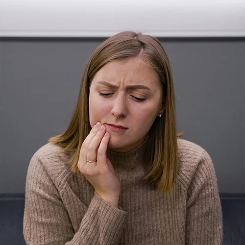 Woman With Tooth Pain Holding Her Jaw